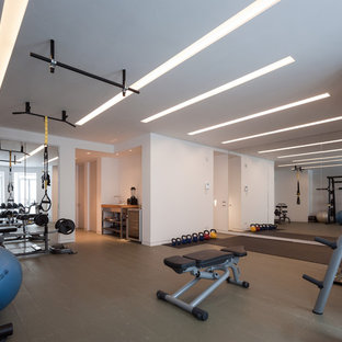 Inspiration for a contemporary look-out basement in London with white walls, painted wood flooring and no fireplace.