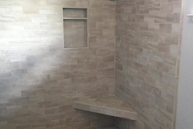 Inspiration for a mid-sized contemporary master beige tile and pebble tile bathroom remodel in Sacramento with recessed-panel cabinets, white cabinets and gray walls