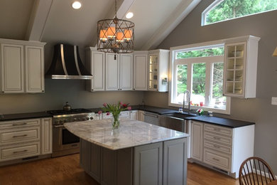 Traditional eat-in kitchen in Dallas with a drop-in sink, raised-panel cabinets, white cabinets, granite benchtops, grey splashback, stainless steel appliances, light hardwood floors, with island, beige floor and white benchtop.