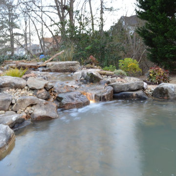 Atlanta Backyard Koi Pond with Large Stone Boulders and Landscaping