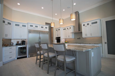 Inspiration for a large contemporary l-shaped porcelain tile and gray floor eat-in kitchen remodel in Miami with an undermount sink, shaker cabinets, white cabinets, quartzite countertops, metallic backsplash, glass tile backsplash, stainless steel appliances, an island and multicolored countertops