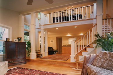 Family room - large transitional open concept light wood floor and brown floor family room idea in Baltimore with beige walls, no fireplace and a concealed tv