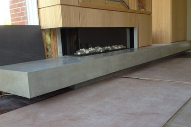 Living room - large contemporary concrete floor and gray floor living room idea in Philadelphia with a ribbon fireplace and a wood fireplace surround