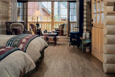 Inspiration for a rustic guest porcelain tile bedroom remodel in Kansas City with beige walls and a wood stove