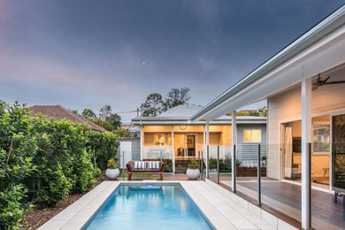 Photo of a mid-sized contemporary backyard rectangular lap pool in Brisbane with decking.