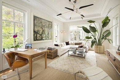 Inspiration for a mid-sized transitional formal and enclosed medium tone wood floor and brown floor living room remodel in New York with white walls and no fireplace