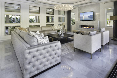 Large contemporary open concept living room in Orange County with white walls, marble floors, a ribbon fireplace, a tile fireplace surround, a wall-mounted tv and grey floor.