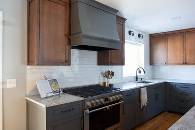 Mid-sized elegant kitchen photo in Minneapolis with a drop-in sink, shaker cabinets, granite countertops, white backsplash, subway tile backsplash, stainless steel appliances, an island, white countertops and gray cabinets