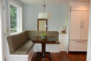 Mid-sized transitional galley medium tone wood floor enclosed kitchen photo in Seattle with an undermount sink, shaker cabinets, white cabinets, granite countertops, multicolored backsplash, matchstick tile backsplash, paneled appliances and a peninsula