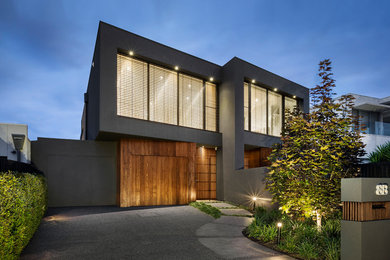 This is an example of a mid-sized modern two-storey black exterior in Melbourne with wood siding.
