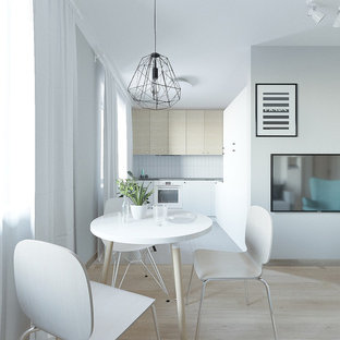 Small scandinavian open plan living room in Other with grey walls, laminate floors, a wall mounted tv and pink floors.