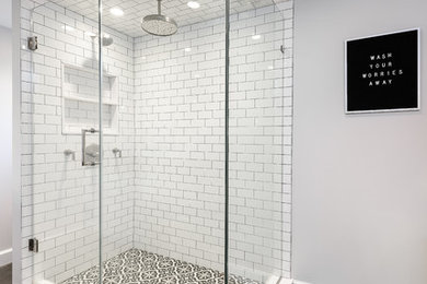 Example of a mid-sized transitional master white tile and ceramic tile cement tile floor and black floor double shower design in New York with shaker cabinets, white cabinets, a bidet, gray walls, a drop-in sink, quartz countertops and a hinged shower door