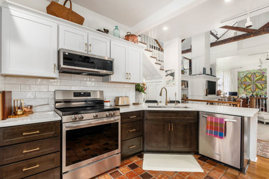Example of a mid-sized classic eat-in kitchen design in Columbus with quartz countertops, white backsplash and ceramic backsplash