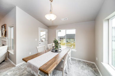 Example of a mid-sized arts and crafts gray floor breakfast nook design in Other with gray walls