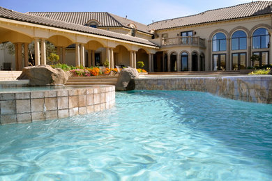 Huge tuscan custom-shaped pool landscaping photo in Other