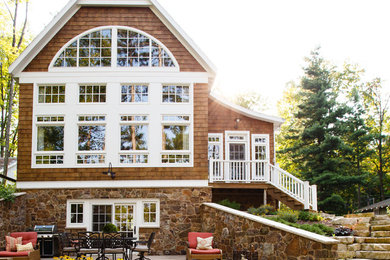 Example of a large transitional brown three-story wood exterior home design in Milwaukee