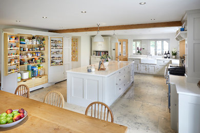 Photo of an expansive traditional l-shaped open plan kitchen in Other with a farmhouse sink, shaker cabinets, grey cabinets, quartzite benchtops, coloured appliances, limestone floors and with island.