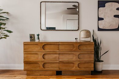Bedroom - contemporary loft-style medium tone wood floor, brown floor and wallpaper bedroom idea in Philadelphia with white walls