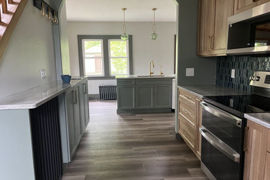 Inspiration for a mid-sized transitional galley eat-in kitchen remodel in Other with shaker cabinets, quartz countertops and an island