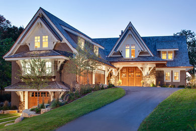 Inspiration for a large traditional three-storey beige duplex exterior in Minneapolis with wood siding, a gable roof and a shingle roof.