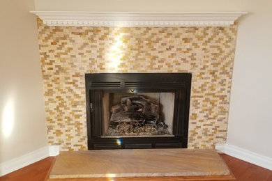 Inspiration for a small coastal medium tone wood floor living room remodel in New York with beige walls and a stone fireplace