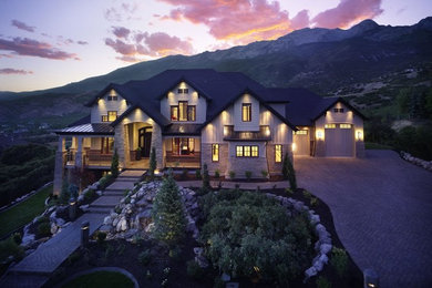 Example of a huge arts and crafts beige three-story mixed siding house exterior design in Salt Lake City with a hip roof and a shingle roof