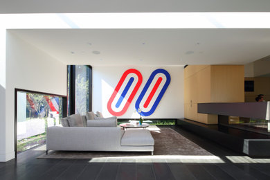 Inspiration for a huge contemporary open concept black floor and porcelain tile living room remodel in Vancouver with white walls, a concealed tv, a two-sided fireplace and a stone fireplace