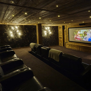 Inspiration for a large rustic enclosed carpeted home theater remodel in Lyon with a projector screen and brown walls
