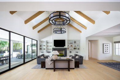 Inspiration for a country exposed beam family room remodel in Phoenix with a stone fireplace