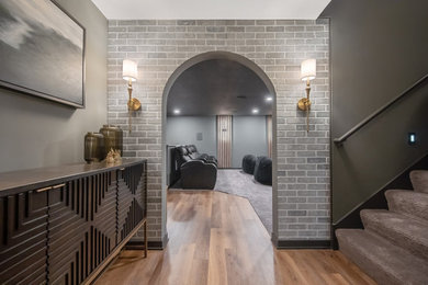 Inspiration for a modern look-out basement remodel in Minneapolis with gray walls