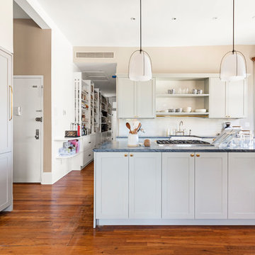 Colossal cabinets and an island are dialed back for a seamless flow (SWEETEN)