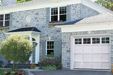 Inspiration for a gray two-story brick exterior home remodel in Boston