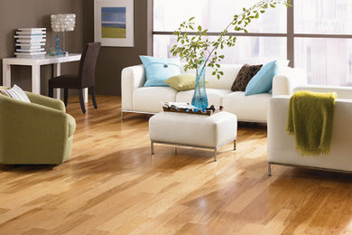 Example of a trendy open concept medium tone wood floor living room design in Other with brown walls
