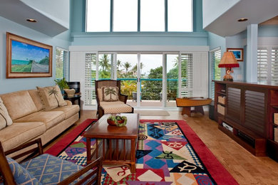 This is an example of a mid-sized tropical formal open concept living room in Hawaii with blue walls and brown floor.