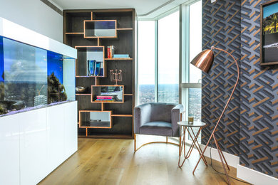 Photo of a medium sized contemporary enclosed living room in London with a reading nook, medium hardwood flooring, white walls and brown floors.