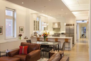 Inspiration for a mid-sized contemporary formal and open concept light wood floor and brown floor living room remodel in New York with white walls, no fireplace and no tv