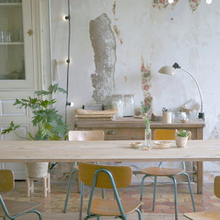 This is an example of a mid-sized traditional open plan dining in Other with multi-coloured walls and terra-cotta floors.