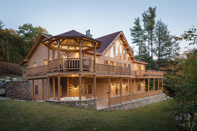 Large rustic two-story wood exterior home idea in Portland Maine with a shingle roof