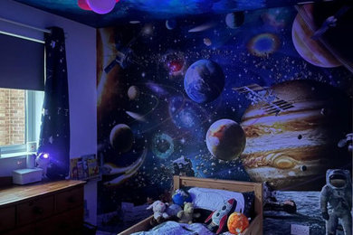 Cette photo montre une chambre d'enfant de 4 à 10 ans tendance de taille moyenne avec un mur bleu et du papier peint.
