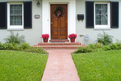 Inspiration for a mid-sized timeless white two-story brick house exterior remodel in Austin with a shingle roof