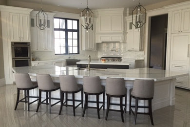 Inspiration for a mid-sized contemporary u-shaped dark wood floor eat-in kitchen remodel in Salt Lake City with an undermount sink, shaker cabinets, white cabinets, granite countertops, white backsplash, subway tile backsplash, stainless steel appliances and an island