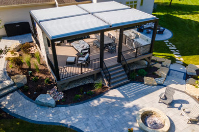 Example of a large transitional backyard metal railing outdoor kitchen deck design in Other with a pergola
