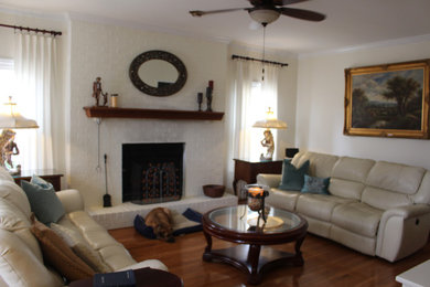 Example of a large classic open concept medium tone wood floor and brown floor family room design in Other with white walls, a standard fireplace, a brick fireplace and a tv stand