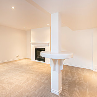 Design ideas for a medium sized classic basement in Toronto with white walls, carpet, a standard fireplace, grey floors and a wooden fireplace surround.