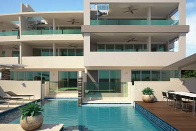 Design ideas for a large modern three-storey exterior in Cairns.
