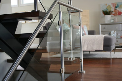 Inspiration for a mid-sized modern formal and open concept medium tone wood floor living room remodel in Ottawa