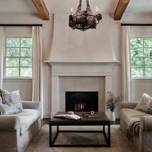 This is an example of a large mediterranean open plan living room in Nashville with medium hardwood flooring, a standard fireplace and a tiled fireplace surround.