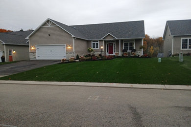 Brown one-story vinyl and shingle exterior home photo in New York with a shingle roof and a gray roof