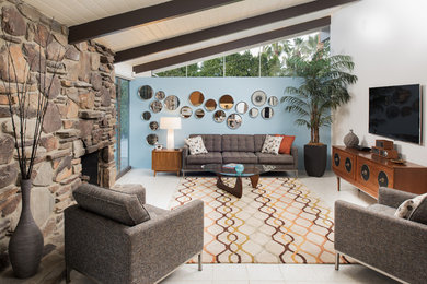 Inspiration for a mid-sized 1950s open concept living room remodel in San Diego with white walls, a stone fireplace and a wall-mounted tv