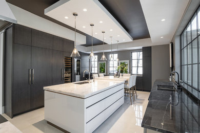 Design ideas for a large contemporary u-shaped separate kitchen in Toronto with flat-panel cabinets, quartzite benchtops, porcelain floors, with island, white floor, a single-bowl sink, white cabinets, white splashback, stone slab splashback, stainless steel appliances and white benchtop.